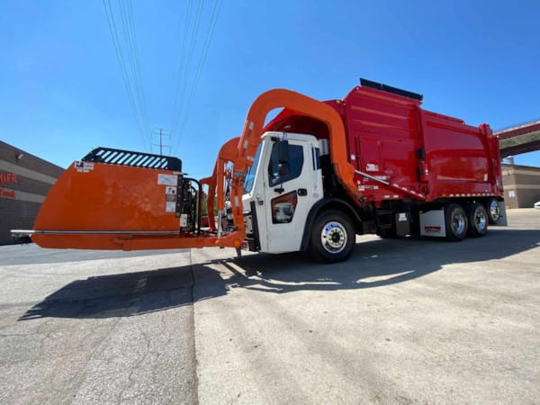 Mack LR64R residential front loader garbage truck left side